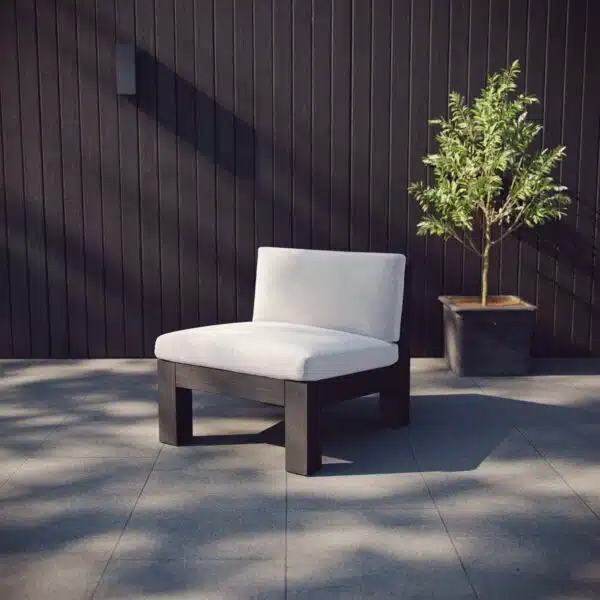 Module sofa on the patio against a black wall