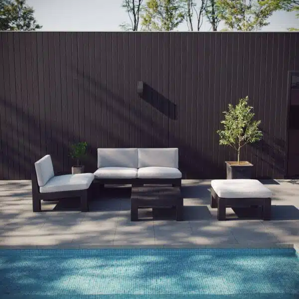 Module sofa group on the patio against a black wall