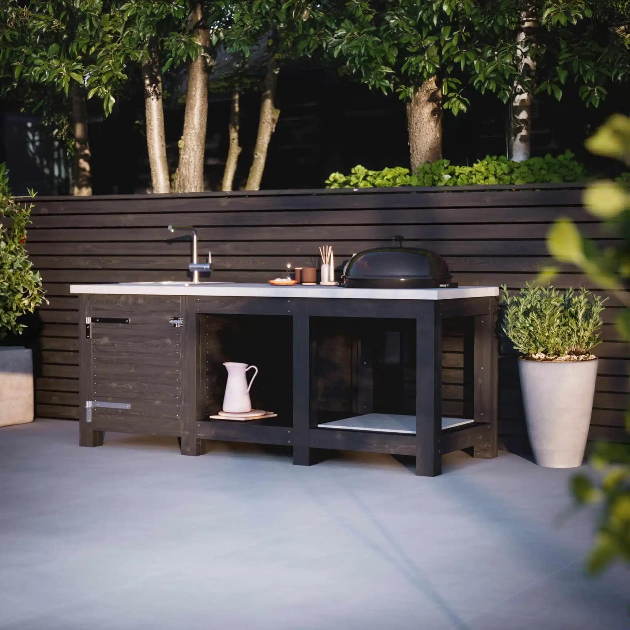 Build an outdoor kitchen with concrete countertop, sink, and built-in grill